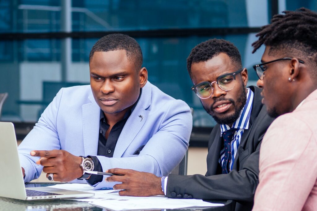 A group of three stylish African American men entrepreneurs in fashion business