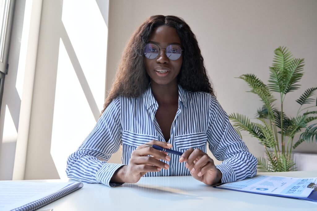 Black woman manager having virtual meeting with diverse business people.