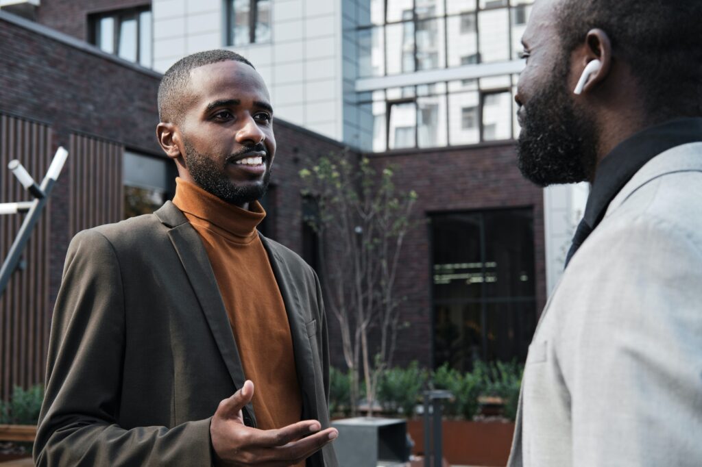 Two Black Men Talking Outdoors