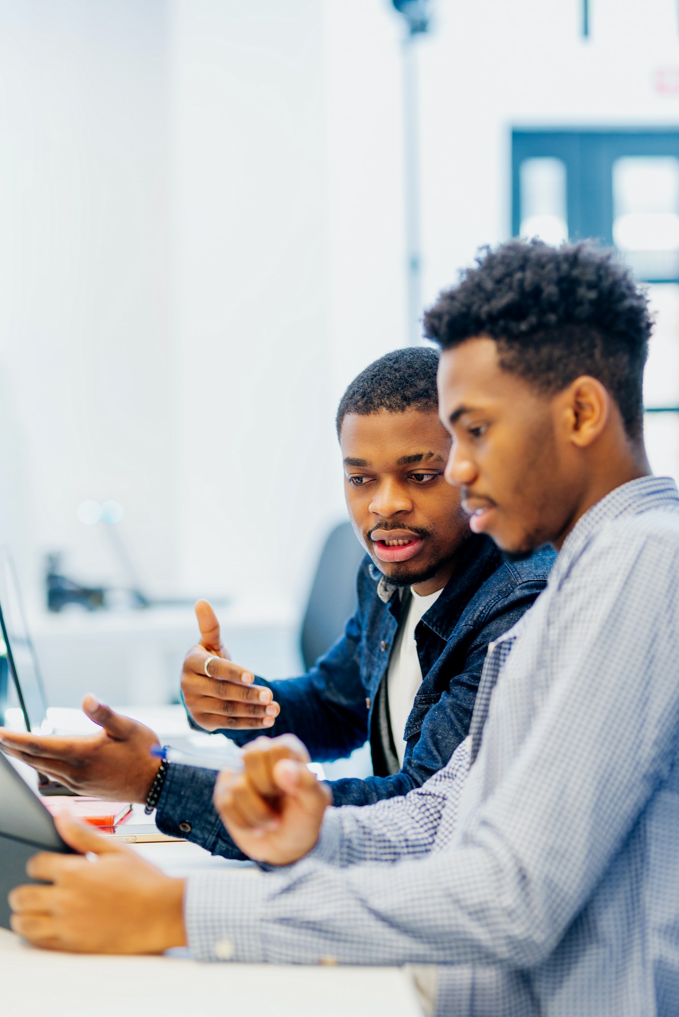 two black men work together