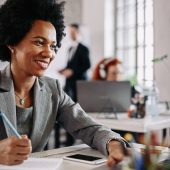 Happy African American woman working in the office.